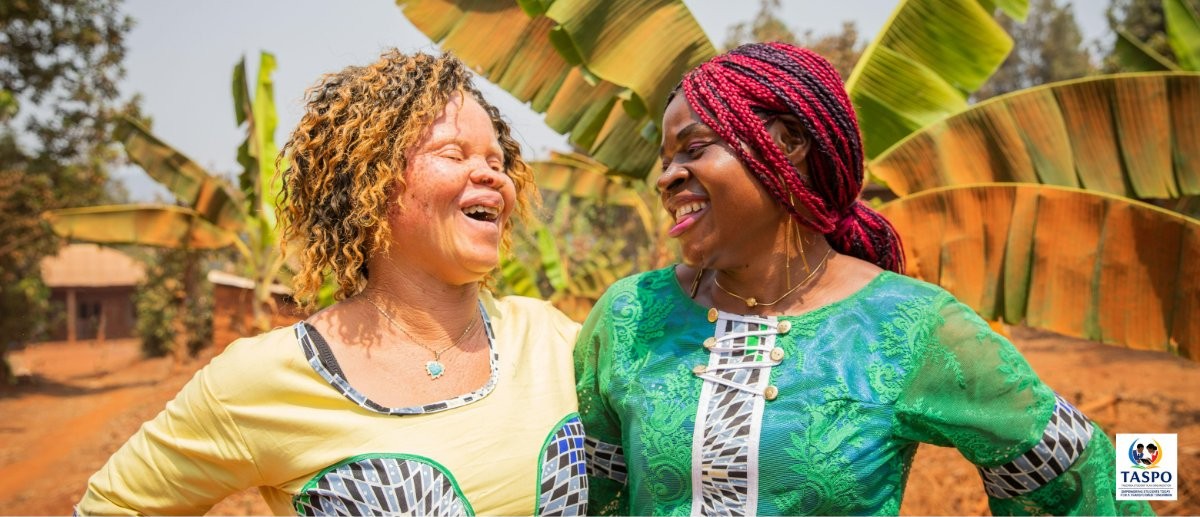 Two friends, one with albinism, laughing together in Tanzania